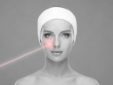 Close-up of a woman receiving a laser facial treatment on the cheek area