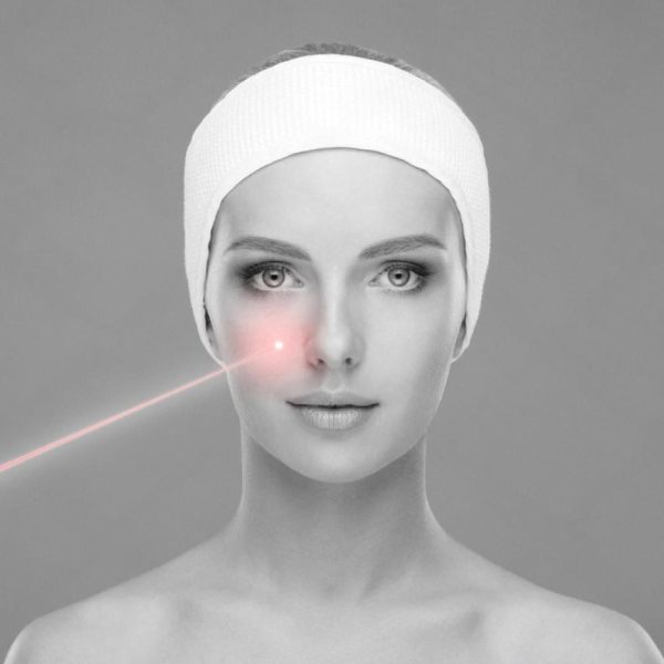 Close-up of a woman receiving a laser facial treatment on the cheek area